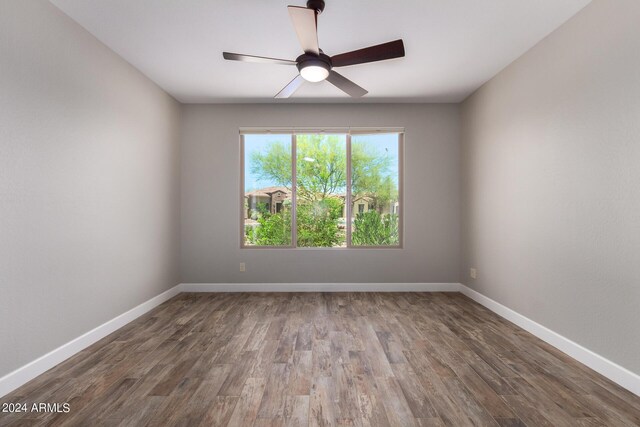 spare room with ceiling fan and dark hardwood / wood-style floors