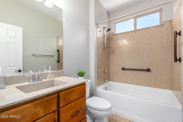 full bathroom featuring vanity, tiled shower / bath combo, and toilet