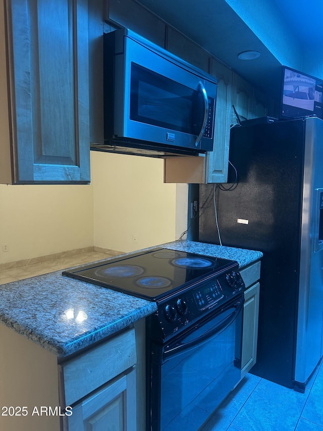 8110 N 31st Dr, Phoenix, AZ 85051 - kitchen with black electric range, light countertops, and light tile patterned flooring