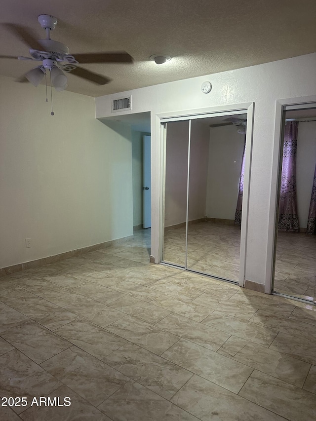8110 N 31st Dr, Phoenix, AZ 85051 - unfurnished bedroom featuring multiple closets and a ceiling fan