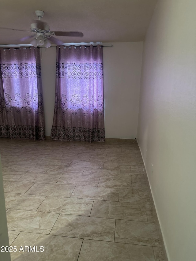 8110 N 31st Dr, Phoenix, AZ 85051 - empty room featuring a ceiling fan and baseboards