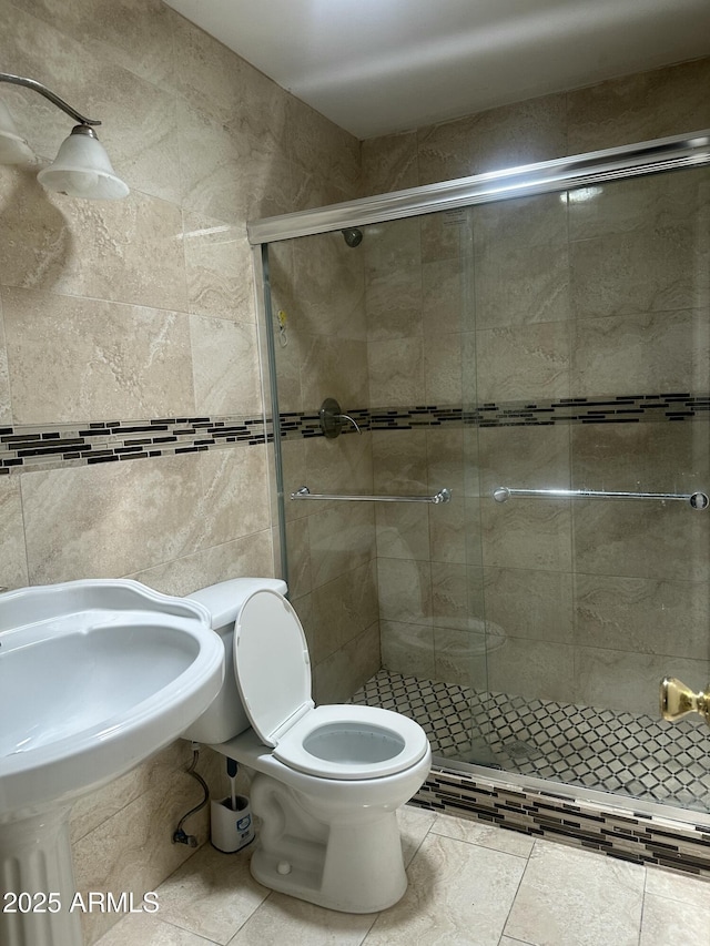 8110 N 31st Dr, Phoenix, AZ 85051 - full bath with a shower stall, tile patterned floors, toilet, a sink, and tile walls