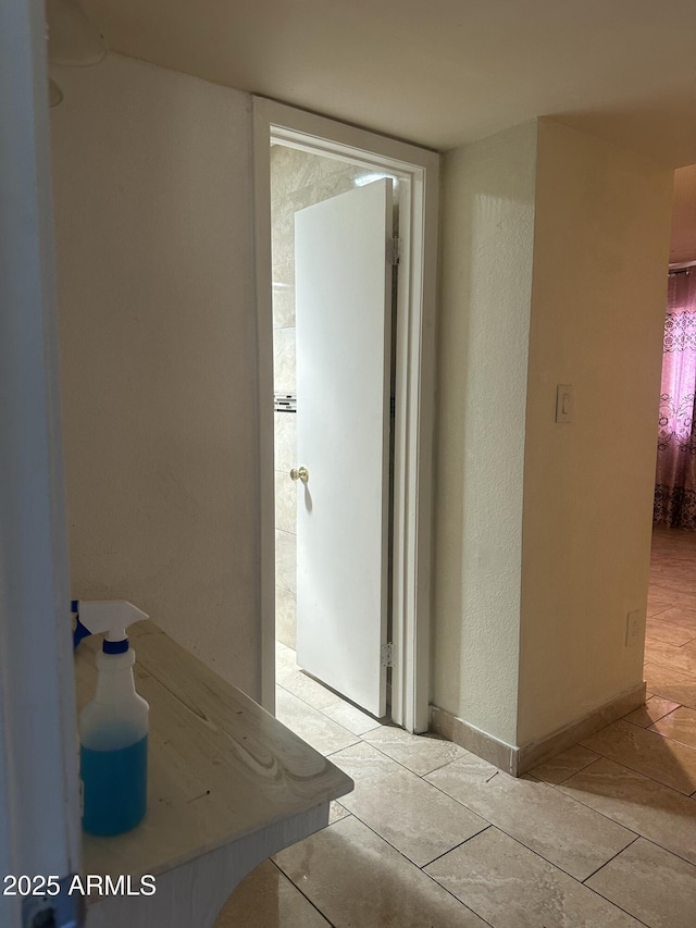 8110 N 31st Dr, Phoenix, AZ 85051 - corridor featuring light tile patterned floors and a textured wall