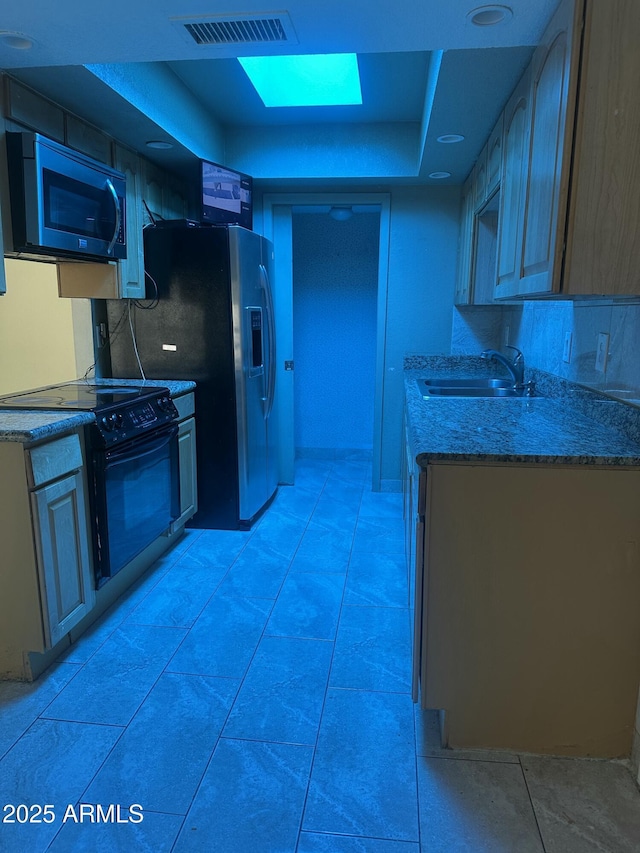 8110 N 31st Dr, Phoenix, AZ 85051 - kitchen with black electric range oven, a sink, light stone counters, a raised ceiling, and stainless steel fridge