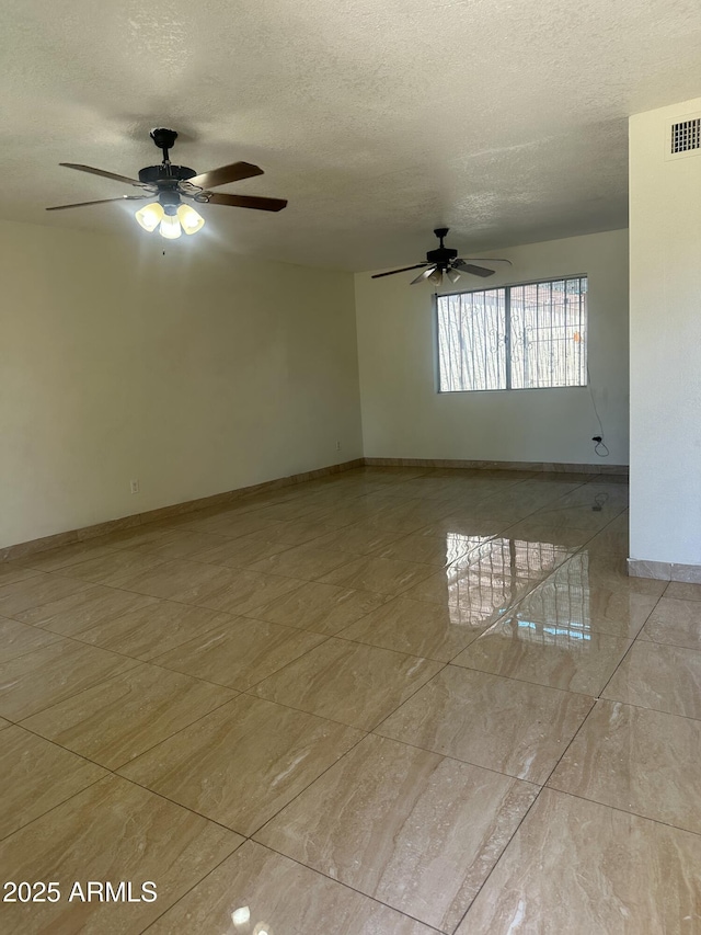 8110 N 31st Dr, Phoenix, AZ 85051 - spare room with ceiling fan, a textured ceiling, baseboards, and light tile patterned floors