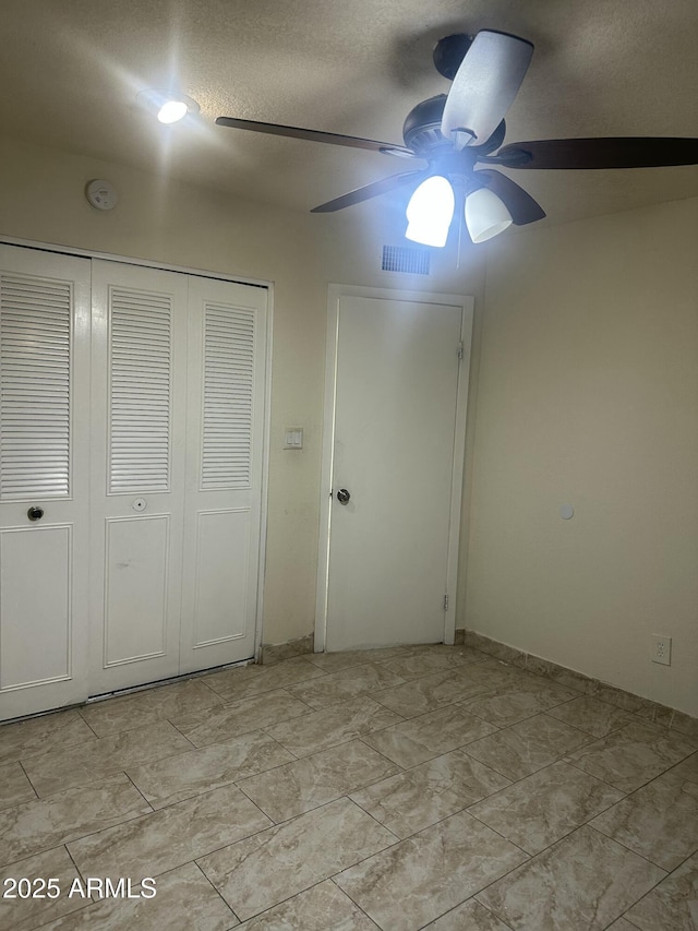 8110 N 31st Dr, Phoenix, AZ 85051 - unfurnished bedroom with a closet, a textured ceiling, and a ceiling fan