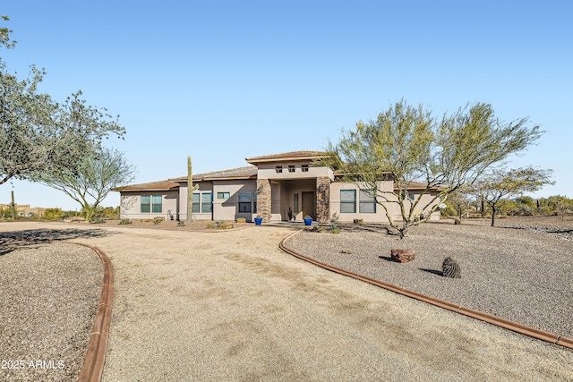 mediterranean / spanish-style home with a tiled roof and stucco siding