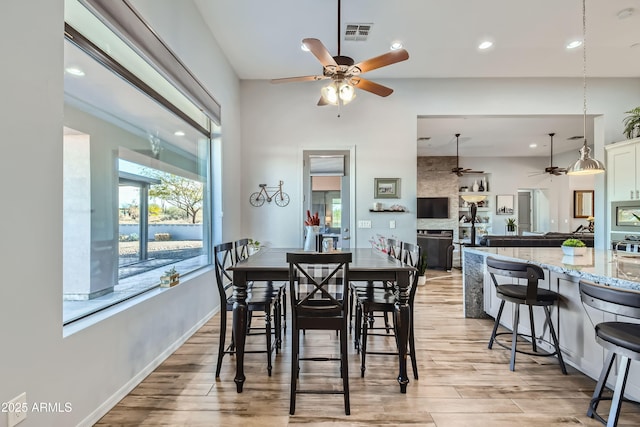 dining space with light wood-style floors, recessed lighting, a ceiling fan, and visible vents