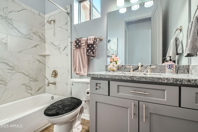 full bath with toilet, vanity, and shower / tub combination