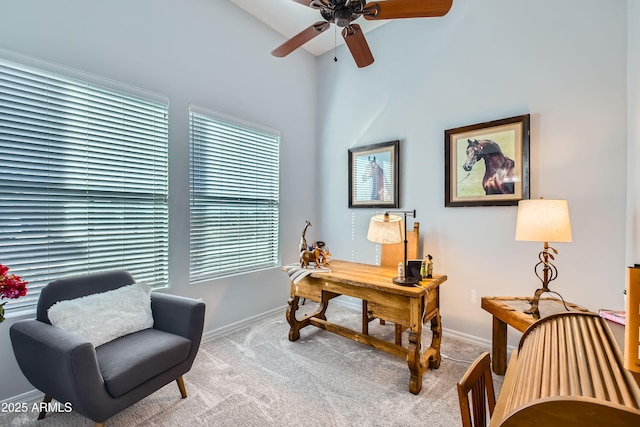 office space with ceiling fan, baseboards, and carpet