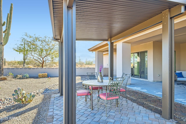 view of patio with outdoor dining area and fence