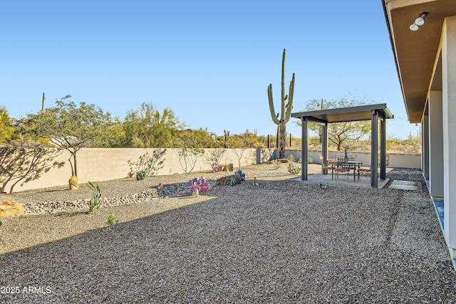 view of yard featuring a patio area and a fenced backyard