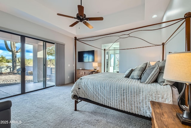 carpeted bedroom with a raised ceiling, recessed lighting, access to exterior, and french doors