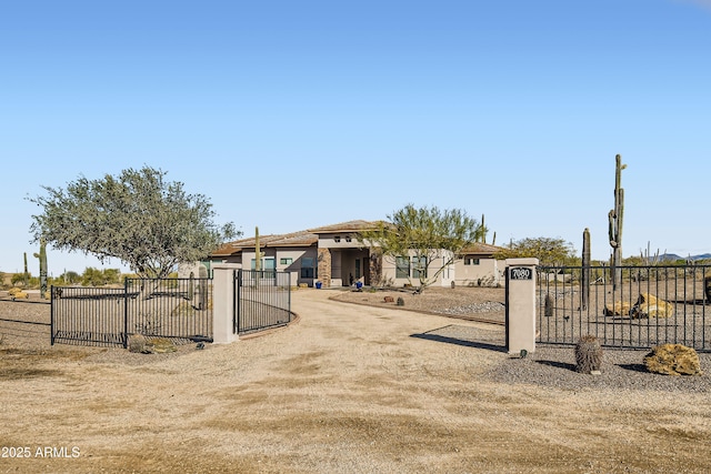 exterior space featuring a fenced front yard, stucco siding, and a gate