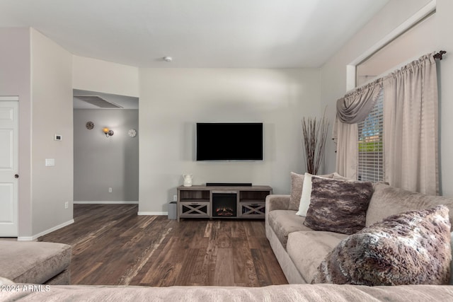 living room with dark hardwood / wood-style flooring