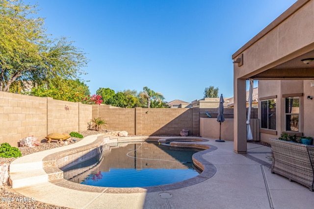 view of pool featuring an in ground hot tub and a patio