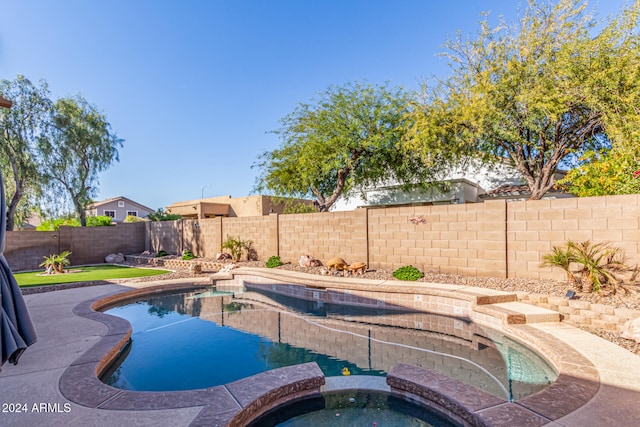 view of pool with an in ground hot tub