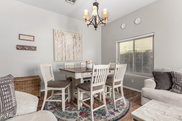 dining room featuring dark hardwood / wood-style floors and a notable chandelier