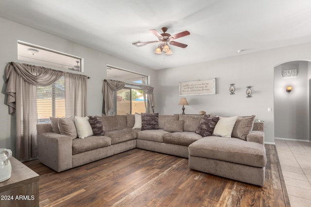 living room featuring dark hardwood / wood-style flooring, plenty of natural light, and ceiling fan