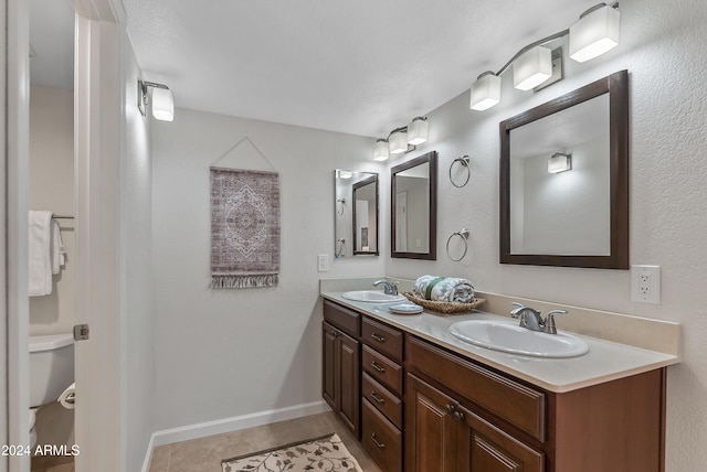 bathroom with vanity, tile patterned floors, and toilet