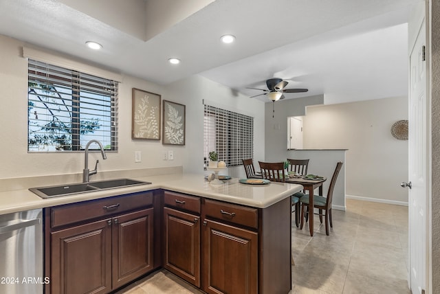 kitchen with light tile patterned flooring, sink, kitchen peninsula, ceiling fan, and dishwasher