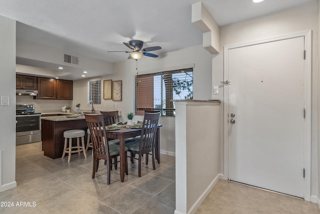 tiled dining area with ceiling fan