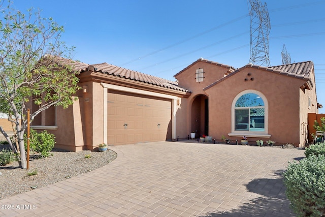 26049 W Matthew Dr, Buckeye, AZ 85396 - mediterranean / spanish-style home featuring a tiled roof, an attached garage, driveway, and stucco siding