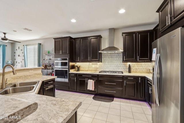 26049 W Matthew Dr, Buckeye, AZ 85396 - kitchen featuring light countertops, appliances with stainless steel finishes, a sink, and wall chimney range hood