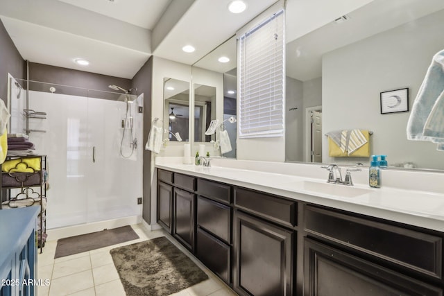 26049 W Matthew Dr, Buckeye, AZ 85396 - full bath with visible vents, a sink, a stall shower, double vanity, and tile patterned floors