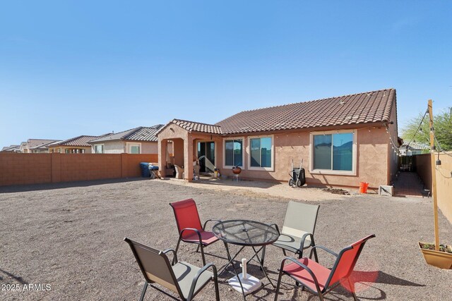 26049 W Matthew Dr, Buckeye, AZ 85396 - back of house with a tiled roof, a fenced backyard, a patio, and stucco siding