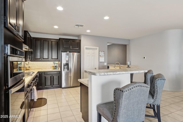26049 W Matthew Dr, Buckeye, AZ 85396 - kitchen with light countertops, light tile patterned flooring, and stainless steel appliances