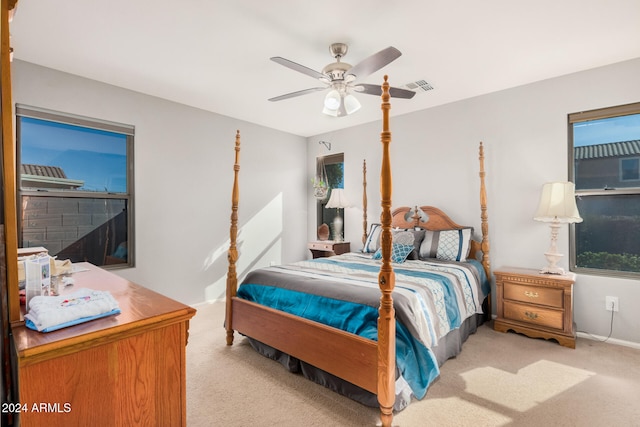 bedroom with ceiling fan and light colored carpet