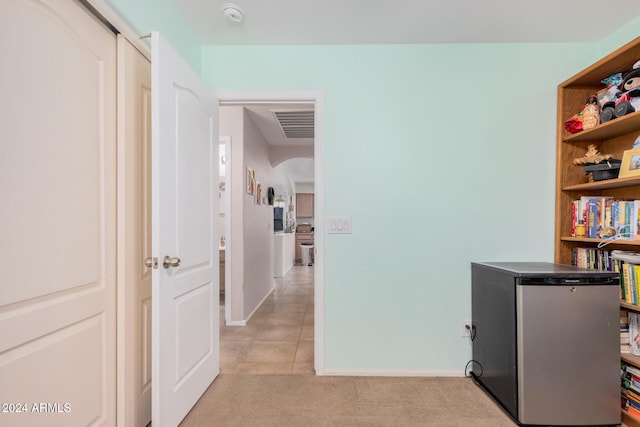 corridor with light tile patterned flooring