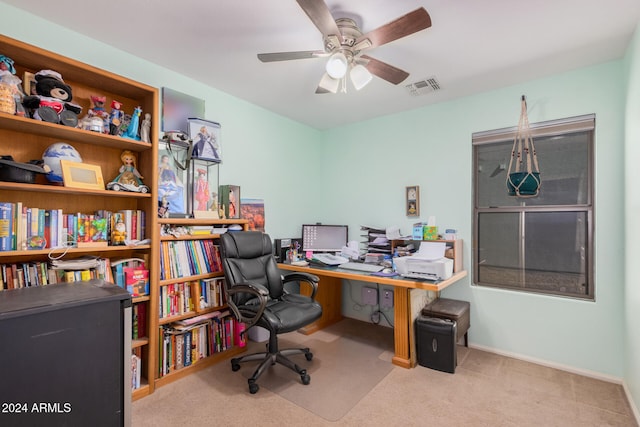 carpeted home office with ceiling fan