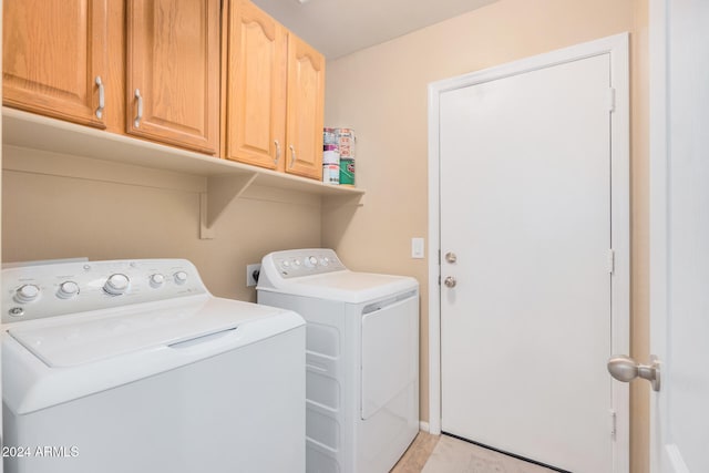 laundry area with cabinets and washing machine and dryer