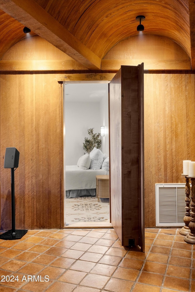 interior space featuring brick ceiling, wood walls, and lofted ceiling