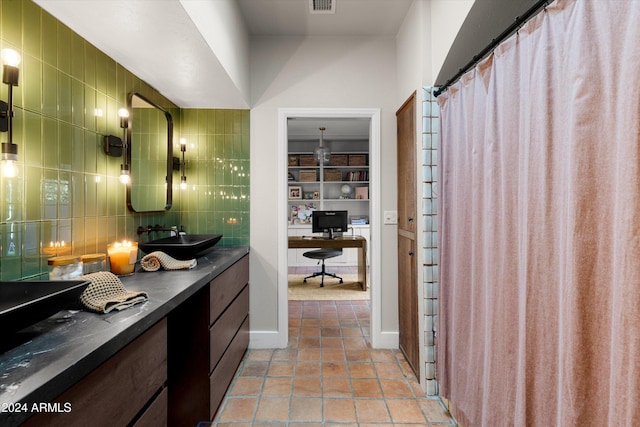 bathroom with backsplash, vanity, tile walls, and tile patterned floors