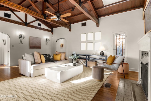 living room with ceiling fan, beamed ceiling, high vaulted ceiling, light hardwood / wood-style floors, and wood ceiling