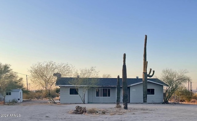 ranch-style home with a storage shed and an outdoor structure