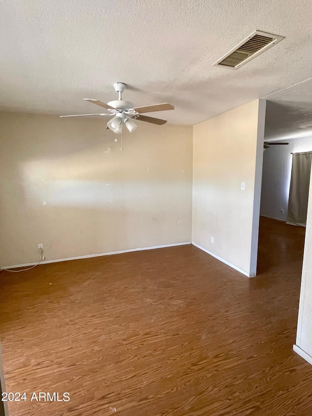 1020 W Schwartz Rd, Ajo, AZ 85321 - empty room featuring ceiling fan, visible vents, a textured ceiling, and wood finished floors