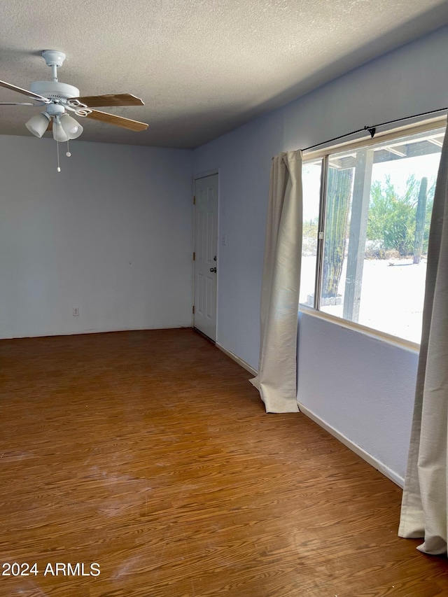 1020 W Schwartz Rd, Ajo, AZ 85321 - spare room with a textured ceiling, ceiling fan, and wood finished floors