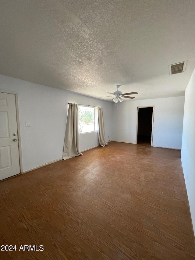 1020 W Schwartz Rd, Ajo, AZ 85321 - empty room featuring visible vents, a textured ceiling, wood finished floors, and a ceiling fan