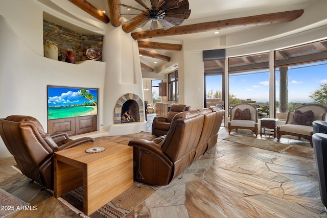 living room featuring a large fireplace and beam ceiling