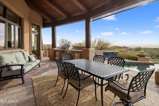 view of patio with area for grilling, an outdoor living space, and grilling area