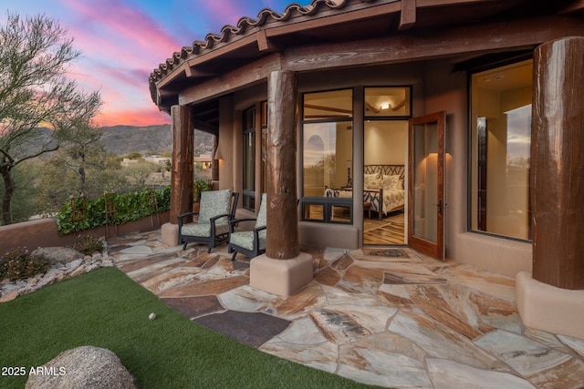 patio terrace at dusk with a mountain view