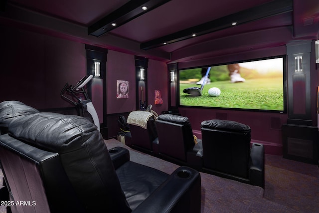 carpeted cinema room with beamed ceiling