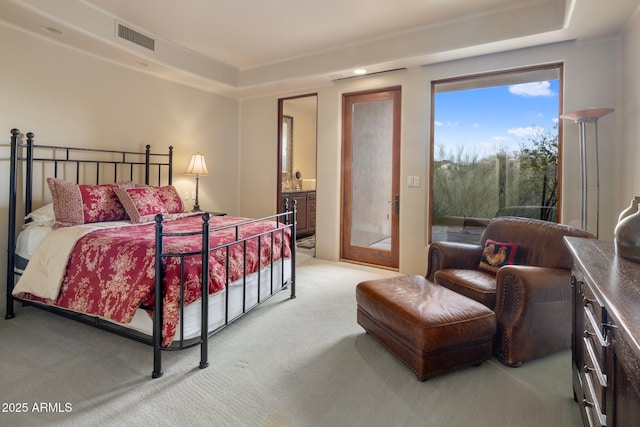 carpeted bedroom featuring ensuite bath