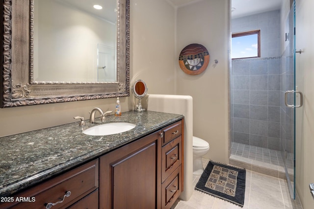 bathroom with vanity, a shower with door, tile patterned floors, and toilet