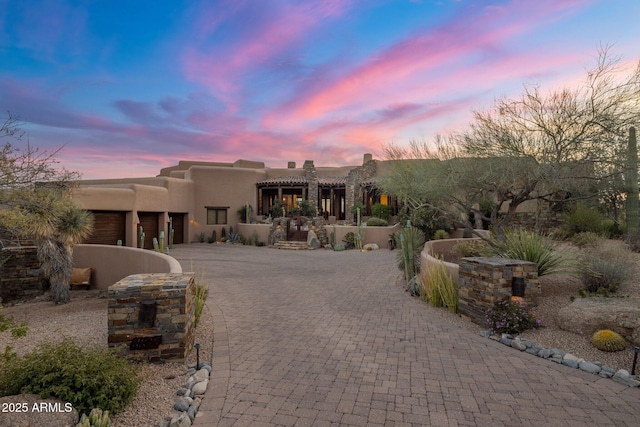 pueblo-style house with a garage