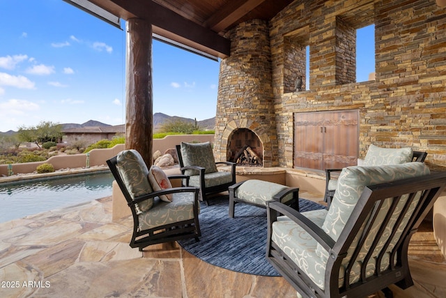 view of patio / terrace featuring an outdoor stone fireplace